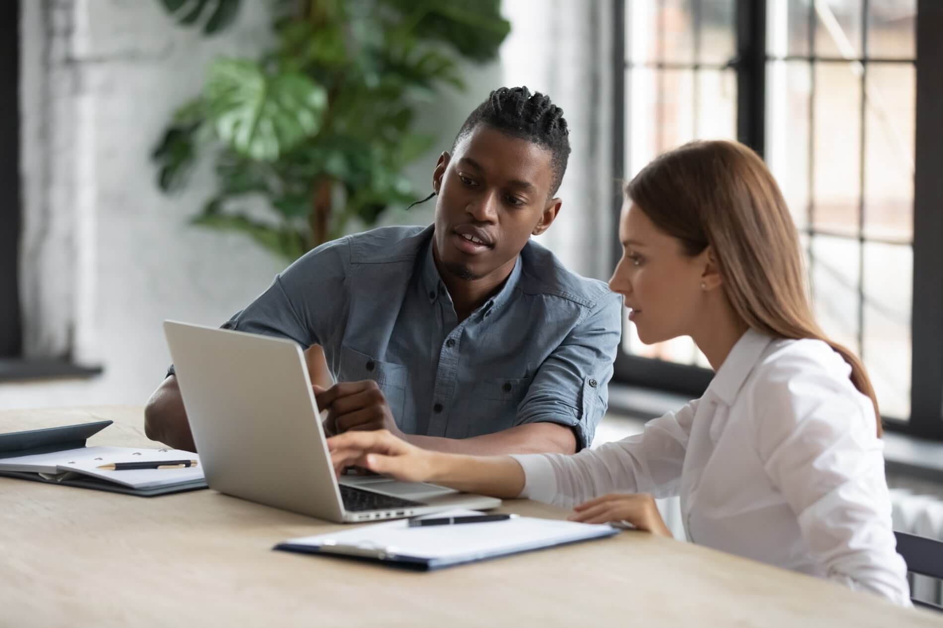 Colleagues looking at laptop at the office